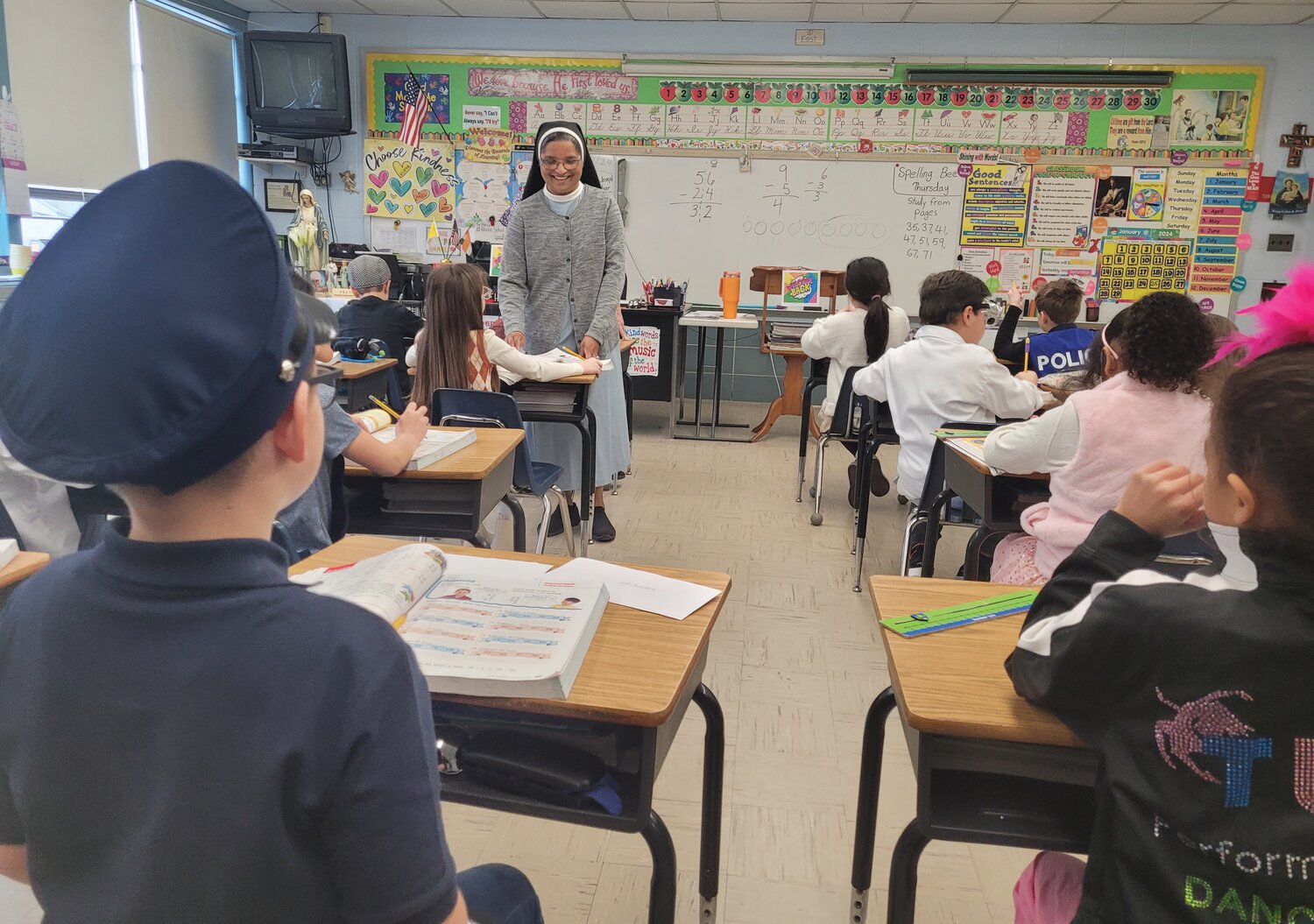 WHEN THEY GROW UP: Students in Sister Daisy Kollamparampil’s second grade class were dressed as their possible future vocations during Career Day on Monday. Sr. Daisy returned to the job on Jan. 10, more than two months after she was seriously injured in the crosswalk outside the school.